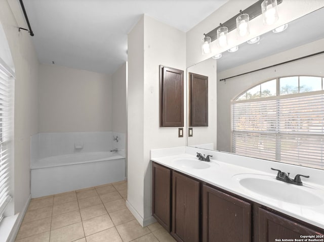 bathroom featuring tile patterned floors, a washtub, and vanity