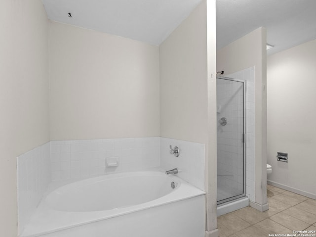 bathroom featuring tile patterned flooring, independent shower and bath, and toilet