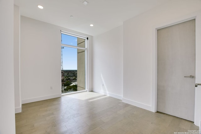 unfurnished room with light hardwood / wood-style flooring