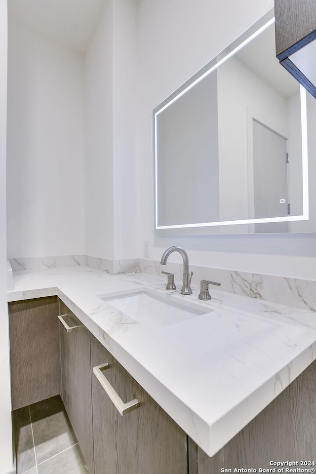 bathroom with tile patterned floors and vanity