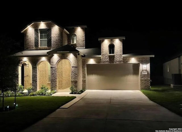 view of front of house with a yard and a garage