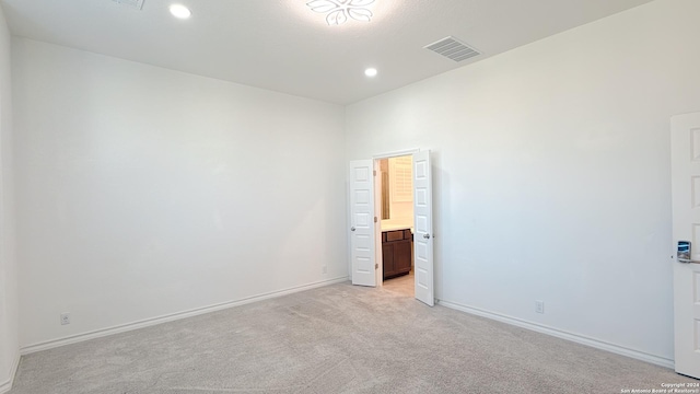 empty room with light colored carpet