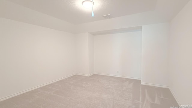 unfurnished room featuring light carpet