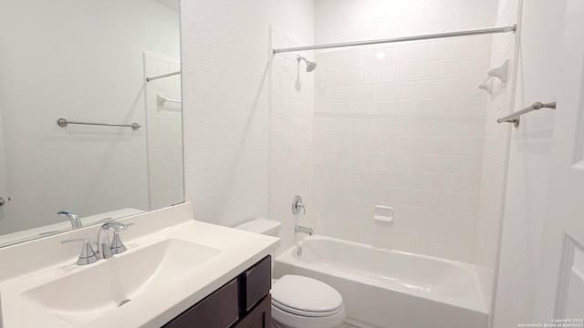 full bathroom with vanity, tiled shower / bath, and toilet