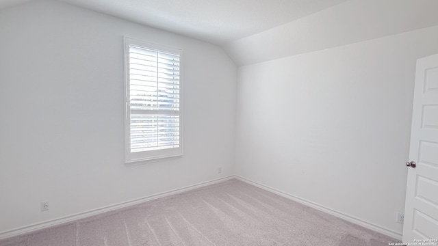 bonus room featuring light carpet and lofted ceiling