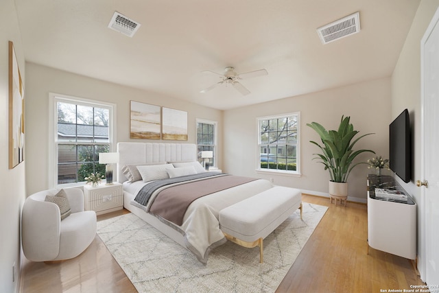 bedroom with ceiling fan and light hardwood / wood-style flooring