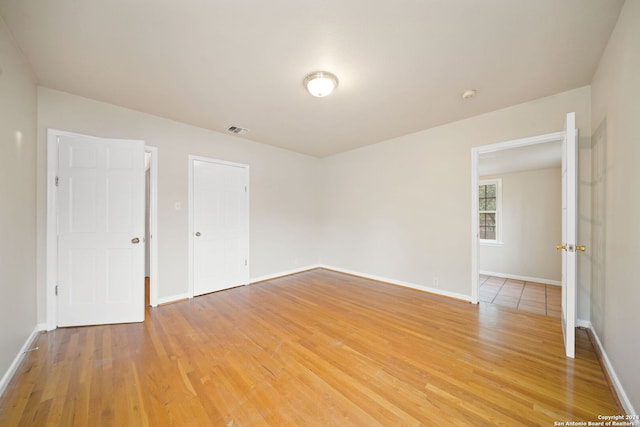 spare room with wood-type flooring