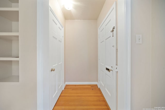 hallway with hardwood / wood-style flooring