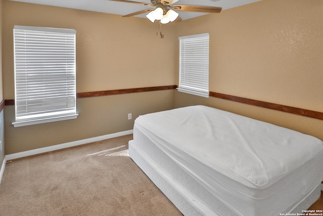 carpeted bedroom with ceiling fan