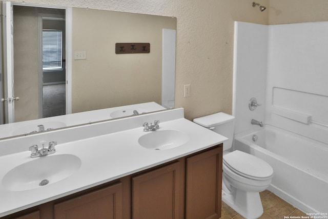 full bathroom featuring tile patterned floors, vanity, toilet, and shower / washtub combination