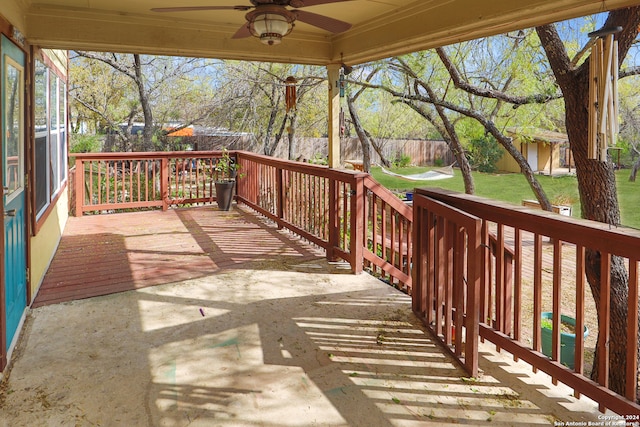 deck with ceiling fan and a yard