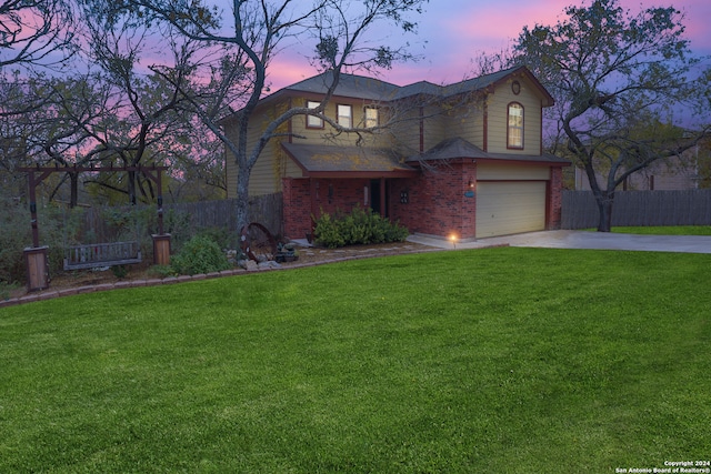 view of front facade with a garage and a lawn