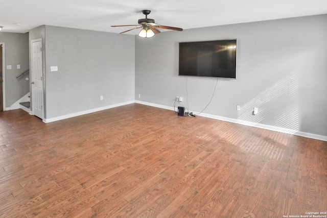 unfurnished living room with wood-type flooring and ceiling fan