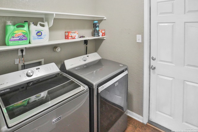 laundry room featuring separate washer and dryer and dark hardwood / wood-style floors