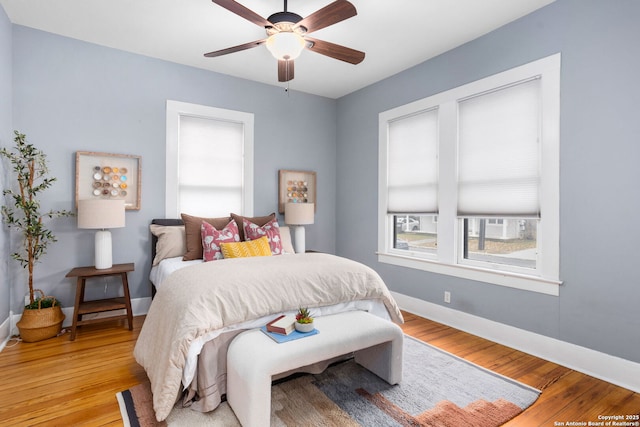 bedroom featuring light wood-style floors, ceiling fan, and baseboards