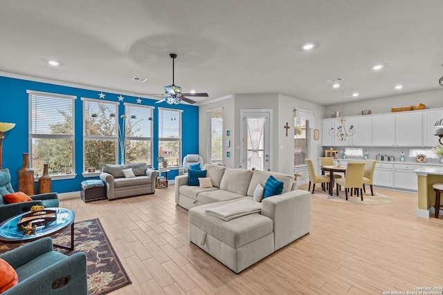 living room with light wood-type flooring and ceiling fan