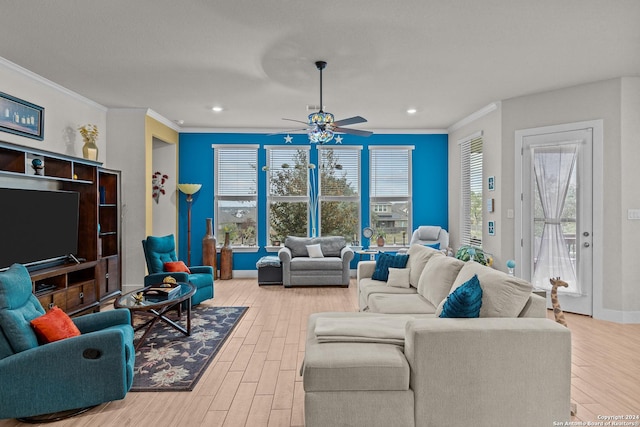 living room featuring light wood-type flooring, ceiling fan, and ornamental molding