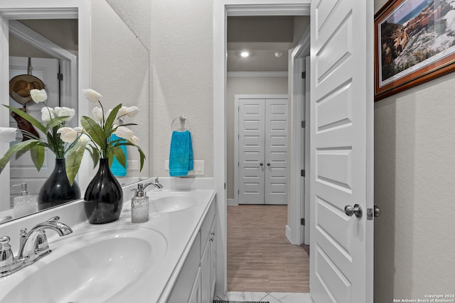 bathroom with vanity and ornamental molding