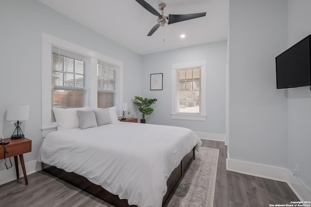 bedroom with ceiling fan and dark hardwood / wood-style flooring