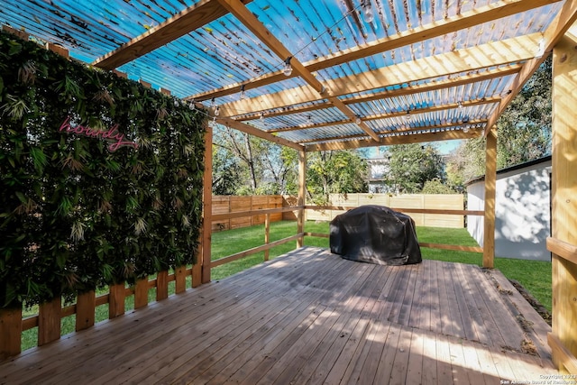 deck featuring a pergola, area for grilling, and a yard