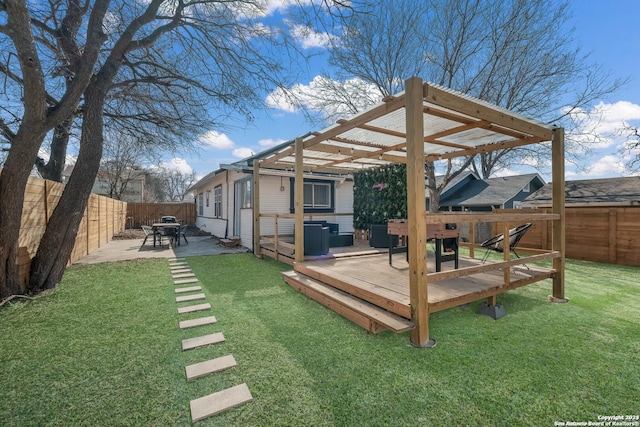 wooden terrace featuring a patio and a lawn