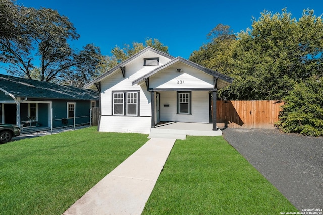 bungalow featuring a front yard and a porch