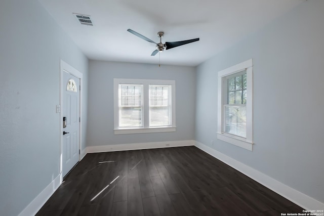 empty room featuring ceiling fan and dark hardwood / wood-style floors