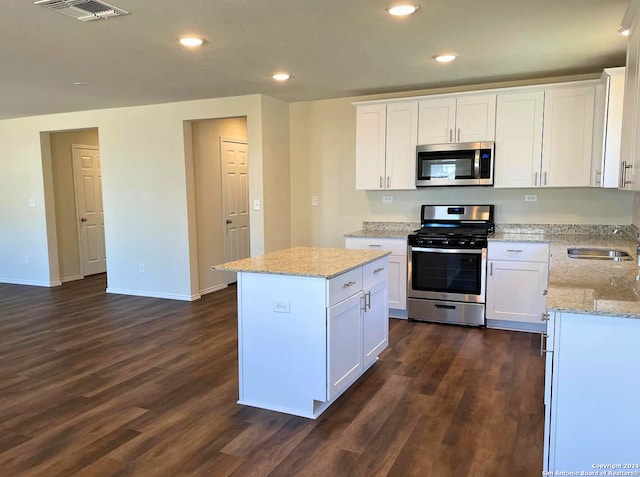 kitchen with white cabinetry, sink, dark hardwood / wood-style floors, and appliances with stainless steel finishes