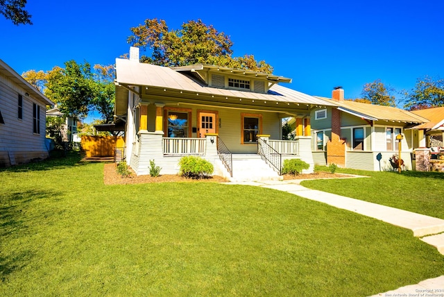 view of front of house featuring covered porch and a front yard