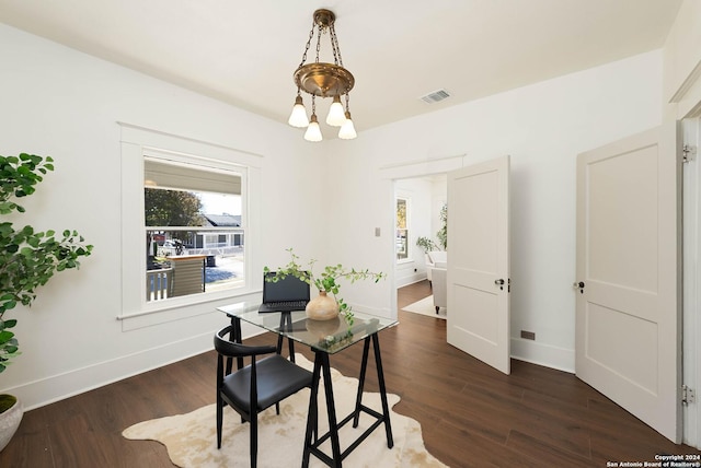 dining space with a chandelier and dark wood-type flooring