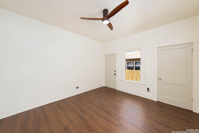 spare room with dark hardwood / wood-style flooring and ceiling fan