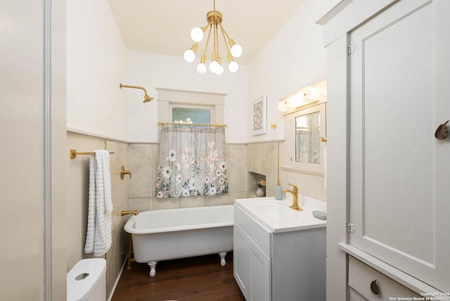 bathroom with a bath, hardwood / wood-style floors, vanity, and a chandelier