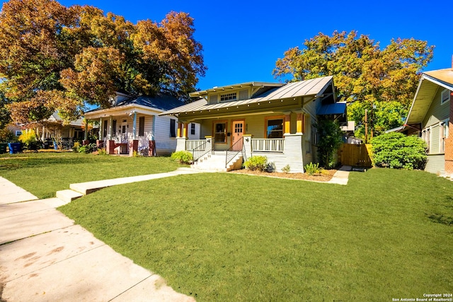 view of front of property with a porch and a front lawn