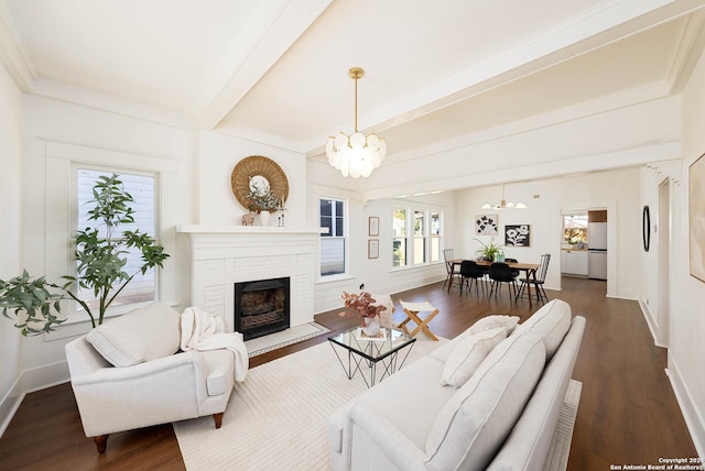 living room with a fireplace, dark hardwood / wood-style floors, an inviting chandelier, and beamed ceiling