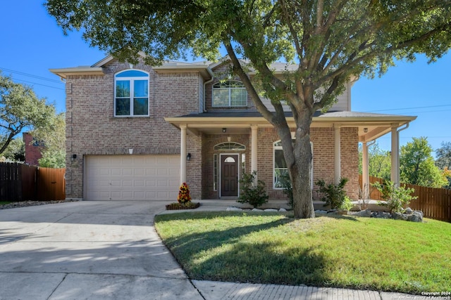 view of front facade featuring a front lawn and a garage