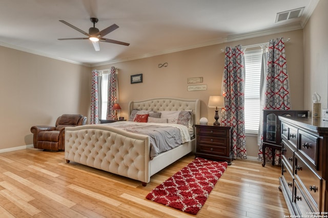 bedroom with light hardwood / wood-style flooring, ornamental molding, and ceiling fan