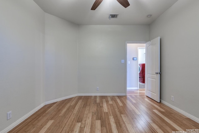 empty room with ceiling fan and light wood-type flooring