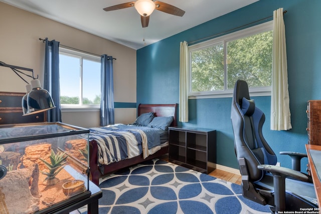 bedroom with hardwood / wood-style flooring and ceiling fan