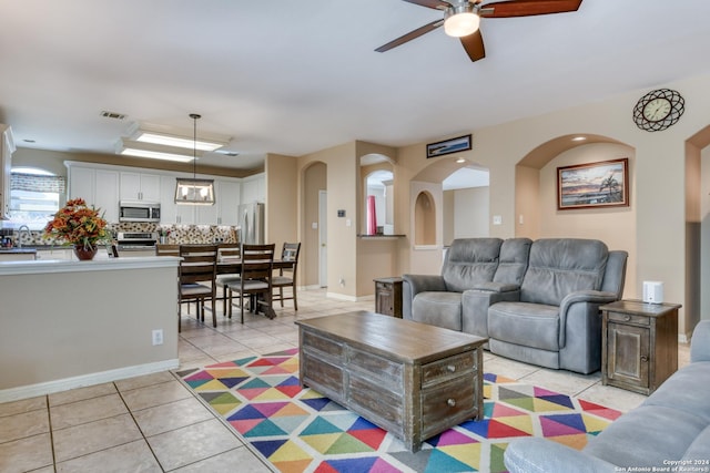 living room with light tile patterned floors and ceiling fan