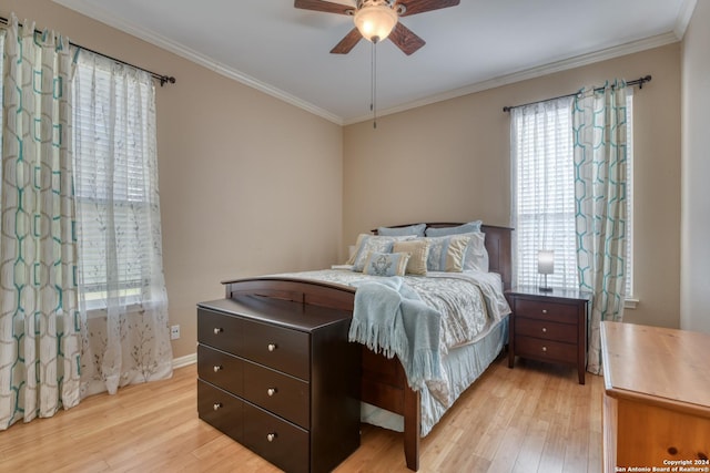 bedroom featuring crown molding, ceiling fan, and light hardwood / wood-style flooring