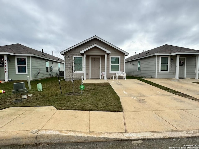 bungalow-style home featuring a front yard