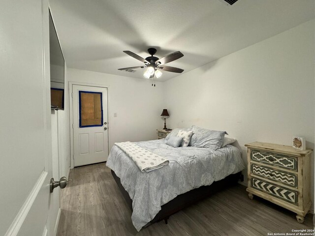 bedroom featuring ceiling fan and dark hardwood / wood-style flooring