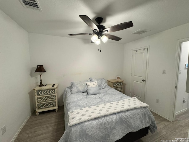 bedroom with ceiling fan and dark wood-type flooring