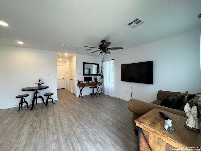 living room with ceiling fan and hardwood / wood-style flooring