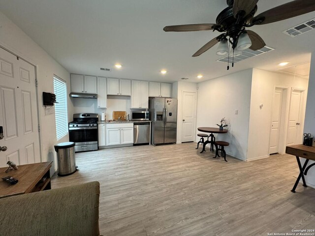 kitchen with ceiling fan, light hardwood / wood-style flooring, white cabinets, and stainless steel appliances