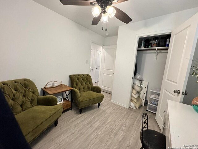 sitting room featuring light hardwood / wood-style flooring and ceiling fan