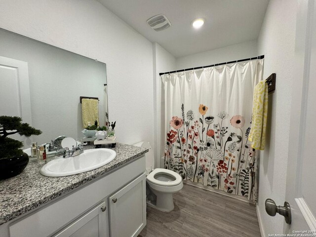 full bathroom featuring toilet, vanity, shower / bath combo, and hardwood / wood-style flooring