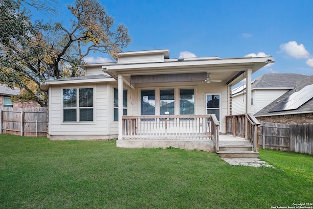 back of property featuring a lawn, ceiling fan, and a porch