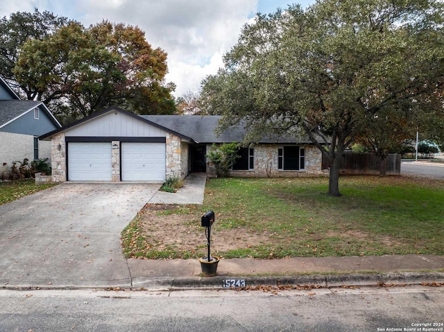 view of front of home with a front yard and a garage