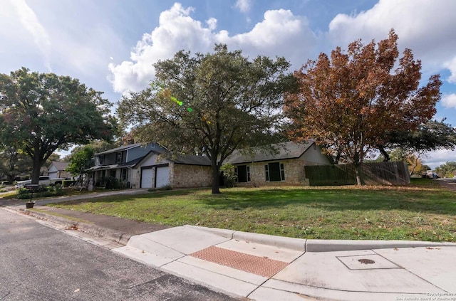 view of front of home featuring a front yard and a garage